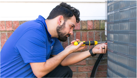 F.H Furr technician performing air conditioning repair