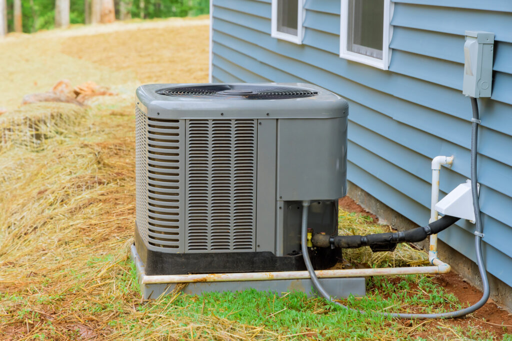 Installation of electric air conditioner residential outside of a home near Washington, DC.