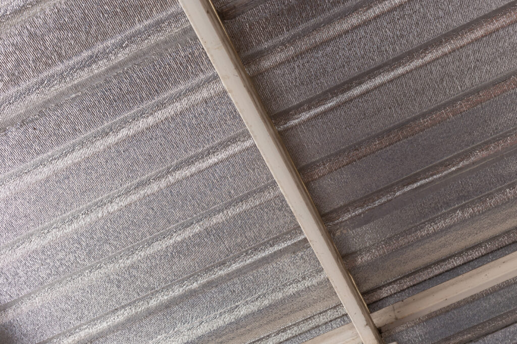 Radiant barrier installed on underside of roof in attic.