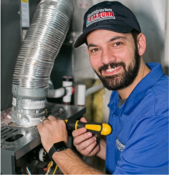 F.H Furr technician performing air conditioning repair