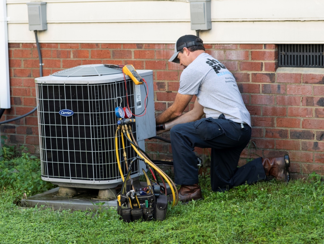 F.H. Furr technician servicing outdoor AC unit.