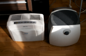 Indoor air quality systems side-by-side on a wood floor.