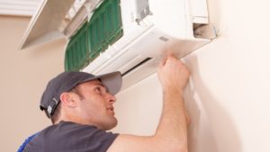 Technician servicing ductless mini-split unit.