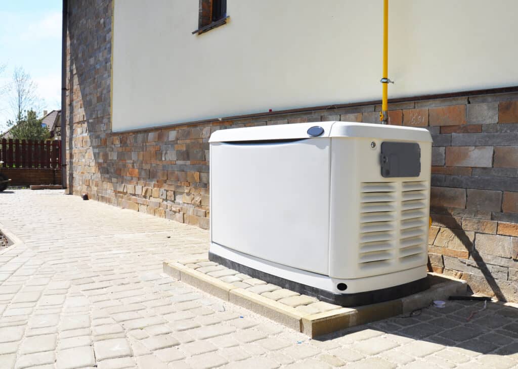 Residential natural gas backup generator next to a white stucco home.