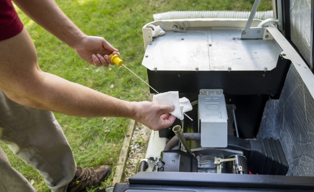Generator technician performing maintenance and repairs on a generator outside.