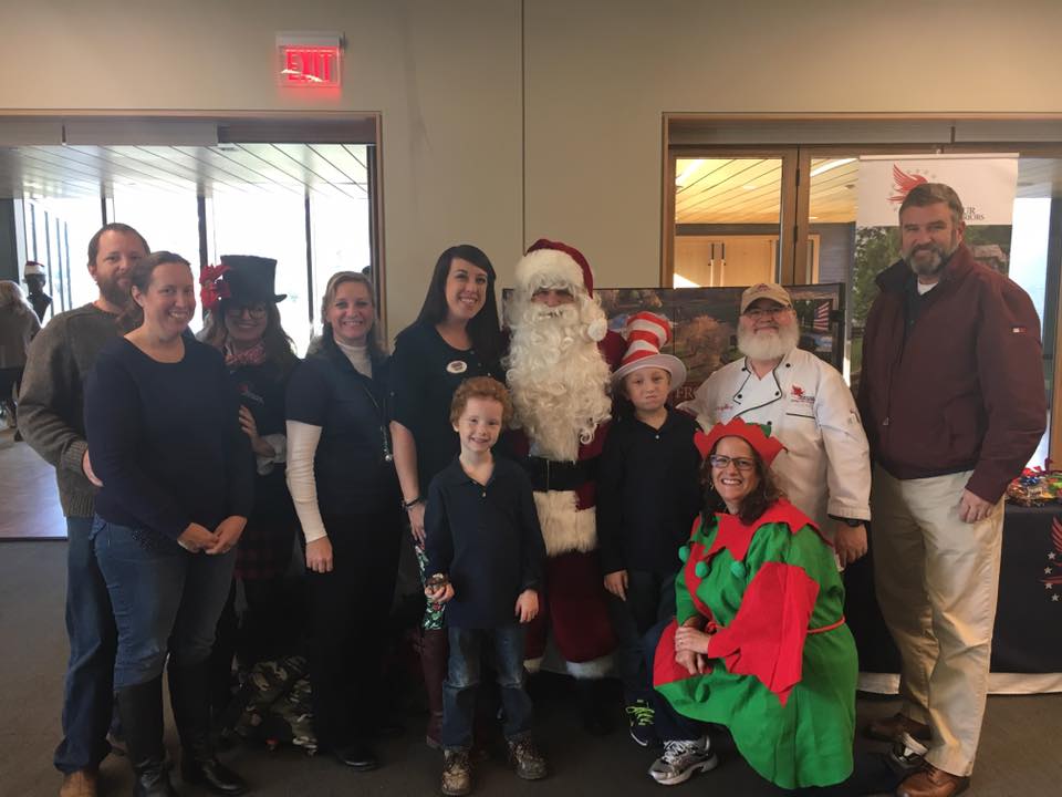 Volunteers posing together around Santa.