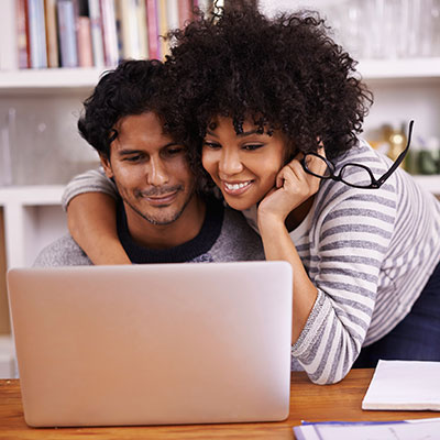 Man and woman reviewing their HVAC financing options on their computer