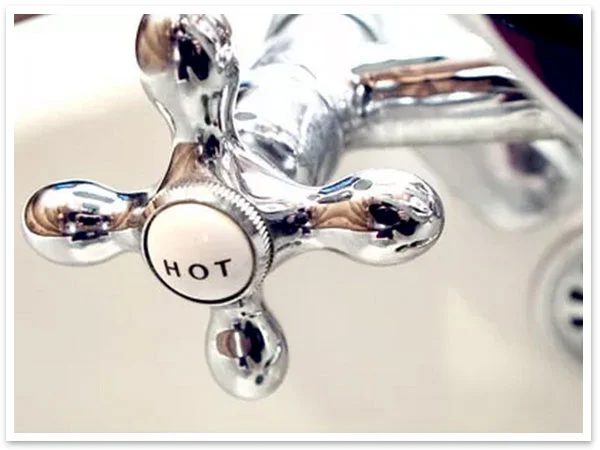 Hot water tap on a bathroom sink.