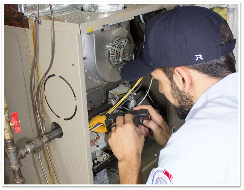 Technician servicing HVAC unit.