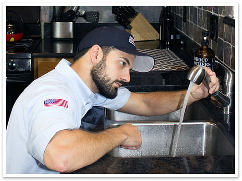 Technician checking a sink faucet