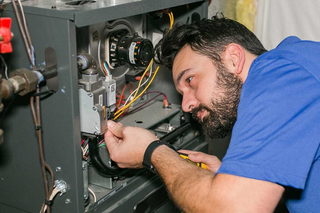 Technician working to repair furnace.