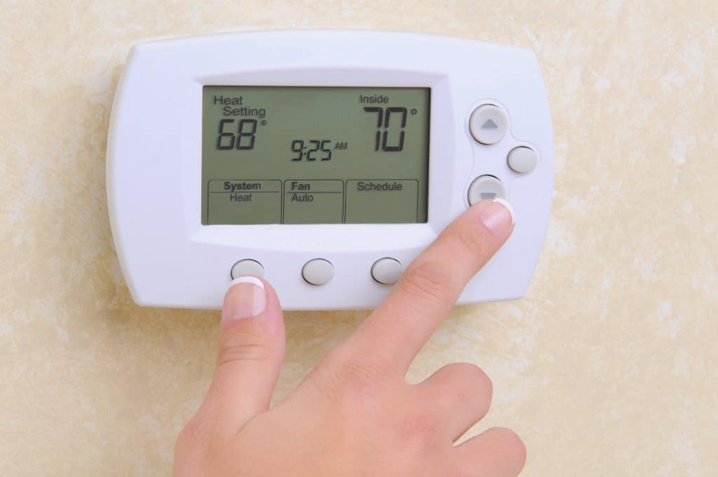 Closeup,Of,A,Woman's,Hand,Setting,The,Room,Temperature,On