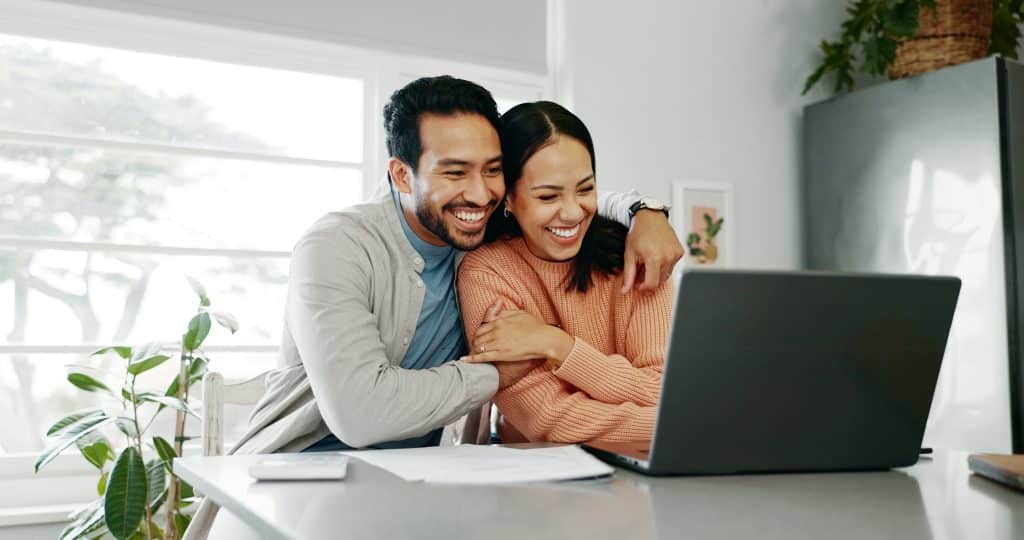 Happy,Couple,,Paperwork,And,Hug,With,Laptop,For,Budget,,Paying